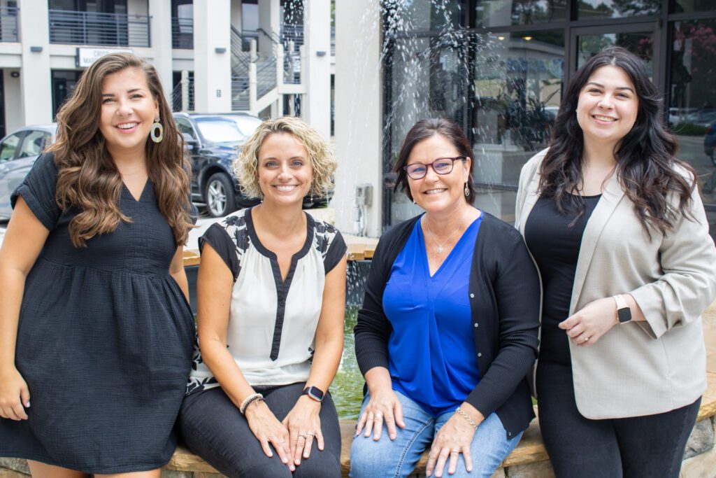 four women standing beside each other outside. The Evoke Wellness therapy team is here for you if you're considering therapy in Wilmington North Carolina