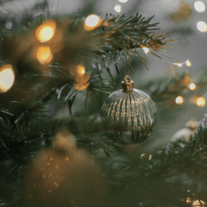 Close up of a Christmas ornament in a tree, muted colors, coping with grief during the holidays
