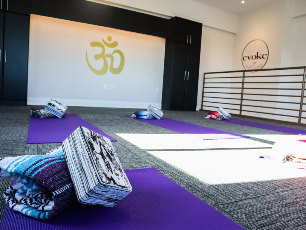 close up of yoga foam block and towel on a mat in the Evoke Wellness yoga studio, Wilmington, NC.
