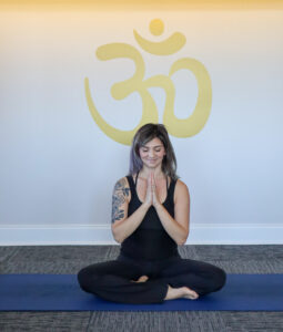 Evoke Wellness yoga instructor Marisa Karoutsos holding a yoga pose, "toxic positivity of good vibes only" blog